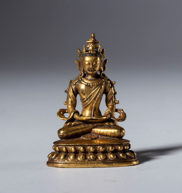 Small gilded copper Buddha statue with a hollow relic base. Tibet, 19th century