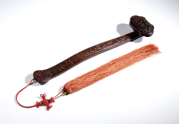 A finely carved wooden Ruyi scepter with archaic-style decorations. A symbol of good luck and happiness. China, Qing Dynasty (1644–1912), 19th century.