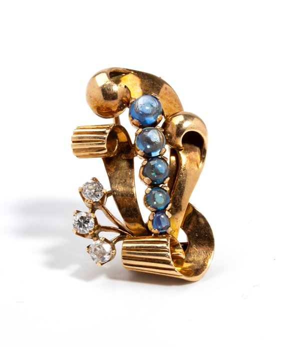 Spilla in oro con diamanti e zaffiri