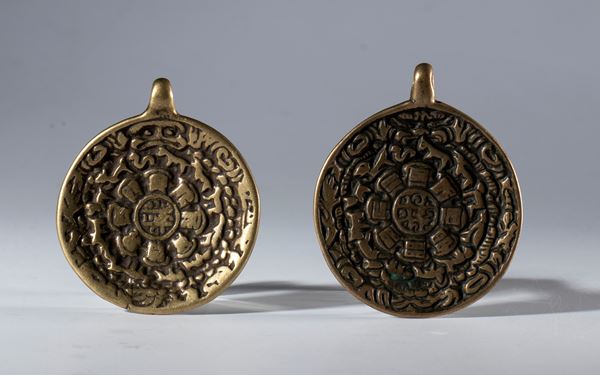 A pair of copper alloy Jiu Gong Ba Gua amulets. Tibet, 19th century.
