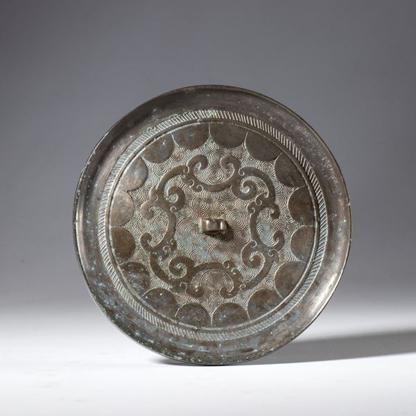 A silver-plated copper mirror used in Taoism as a ritual instrument. China, 19th century.