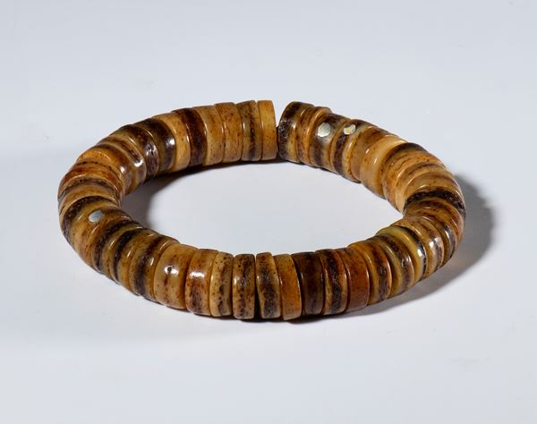 A rare ornamental bracelet made with forty-five bone beads obtained from the worn beads of prayer wheels. Tibet, 19th century