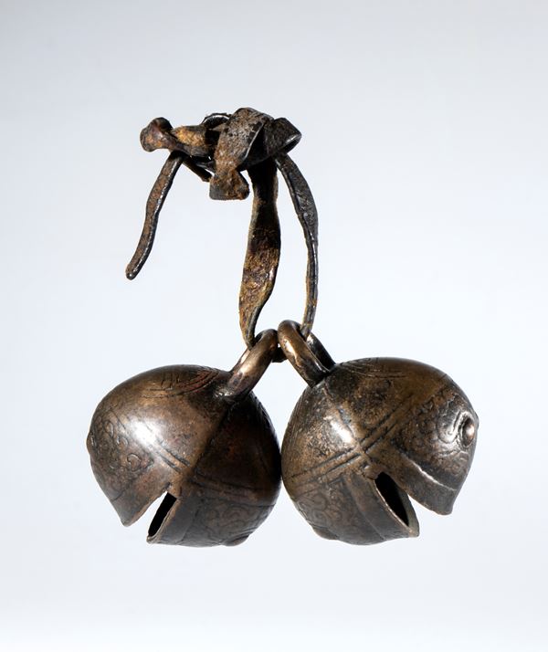 A pair of embossed and engraved copper bells depicting schematic tiger heads. China, 19th century