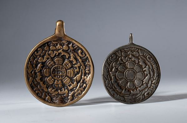 A pair of copper alloy Jiu Gong Ba Gua amulets. Tibet, 19th century.