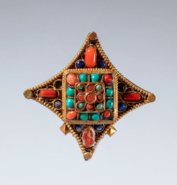 A Gau amulet holder made of gilded copper and semiprecious stones. Tibet, 19th century