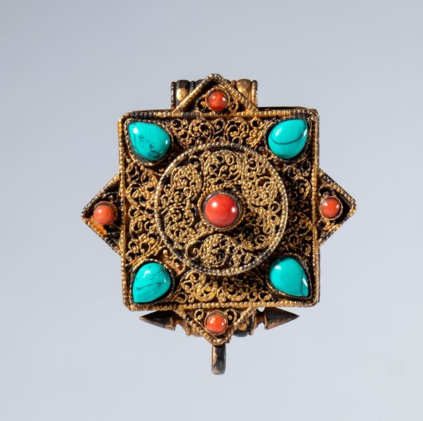 A Gau amulet holder in gilded silver and semiprecious stones. Tibet, 19th century