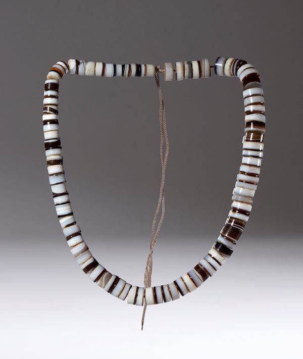 A necklace of discoid zoned agate beads. China, 19th century.