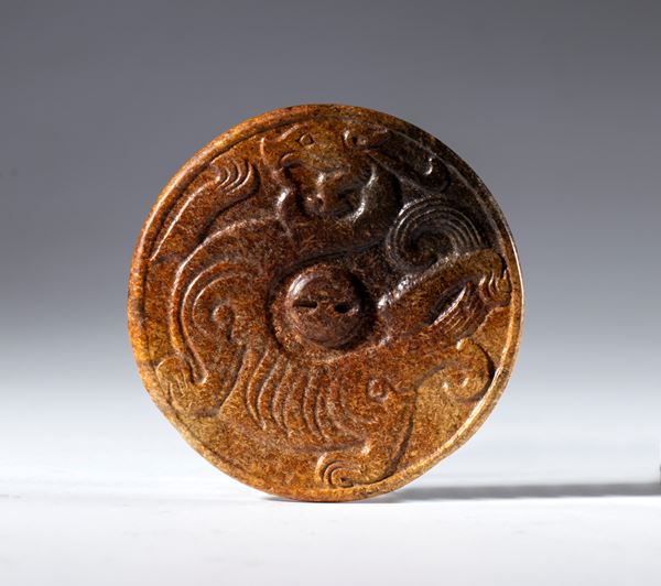 A Hotan jade disc with an embossed dragon and hanging hole. China, 17th century.
