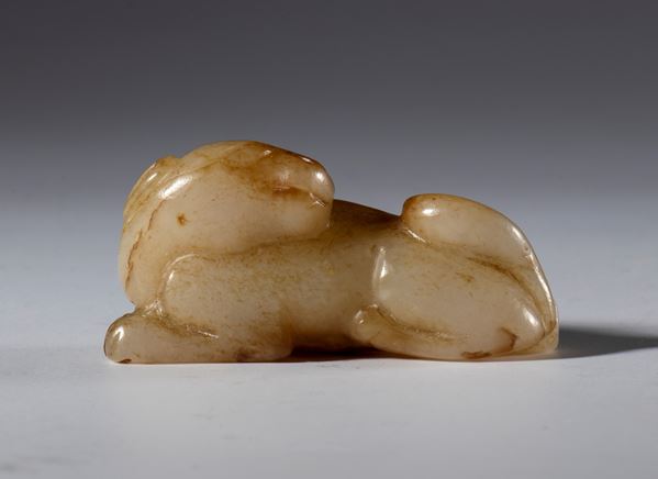 Hotan and russet jade sculpture depicting a small dog. China, 19th century