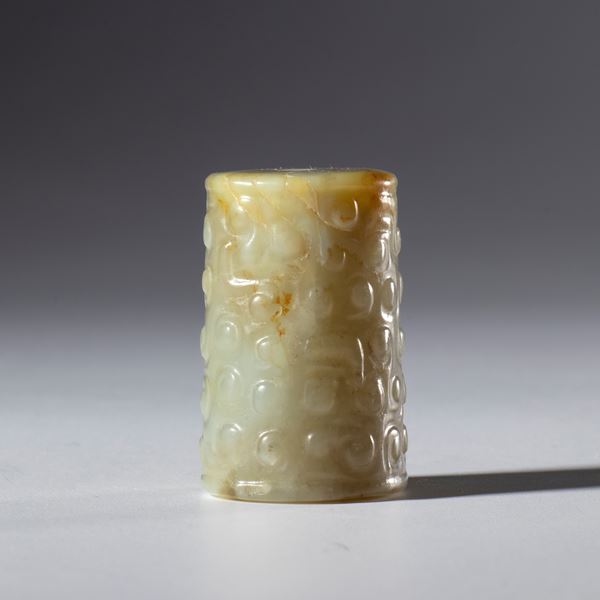 A tubular Hotan jade pendant decorated with a cloud motif. China, 19th century.