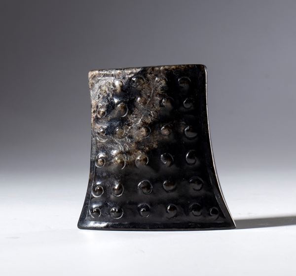 A dark Hotan jade pendant decorated with a rice grain motif. China, 16th century.