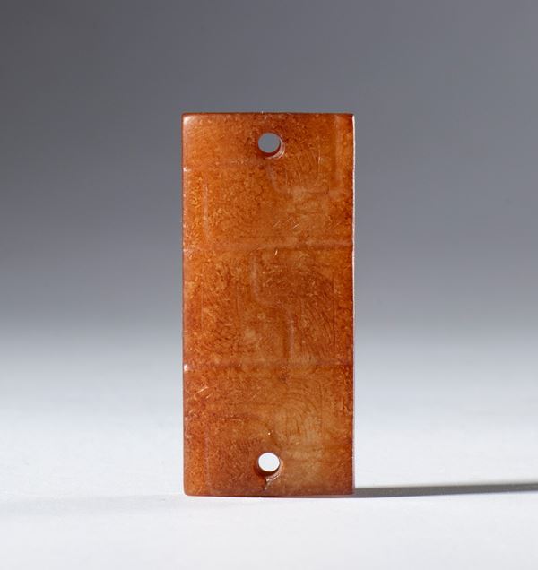 A Hotan jade ornamental plaque engraved with geometric patterns, with holes for hanging. China, 18th century
