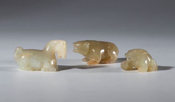 A lot of three small Hotan jade figures depicting a horse, a bear, and a mythical beast. China, 19th century.