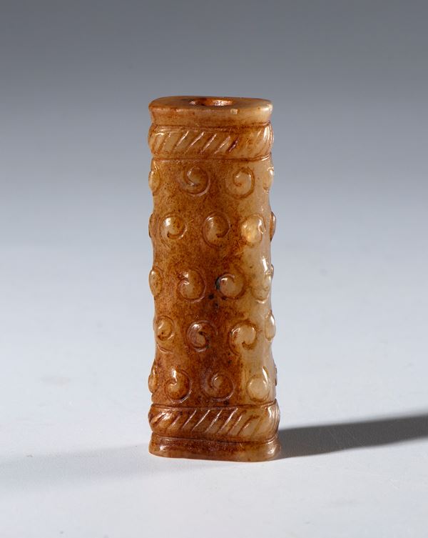 Ornamental tubular pendant in Hotan jade with rice grain decoration. China, Ming dynasty (1368–1644), 16th century.