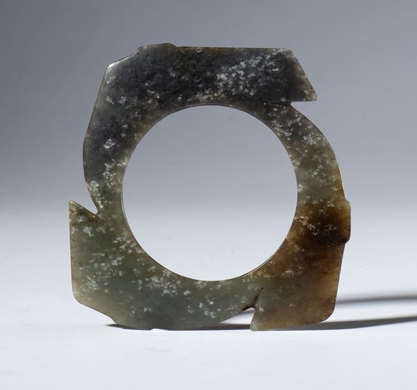 A dark nephrite jade Xuan Ji disc carved in the archaic style. China, Qing Dynasty (1644–1912), late 19th century.