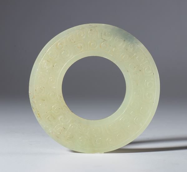 A jade BI disc engraved with a small spiral motif. China, Qing Dynasty (1644–1912), late 19th century.