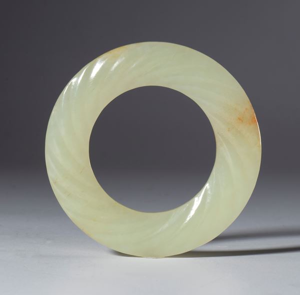 A clear jade BI disc with a spiral body. China, Qing Dynasty (1644–1912), late 19th century.