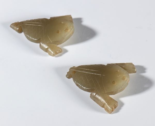 A pair of small, light jade plaques in the shape of a three-legged frog, a symbol of good luck. China, Qing Dynasty (1644–1912), late 18th–19th century.