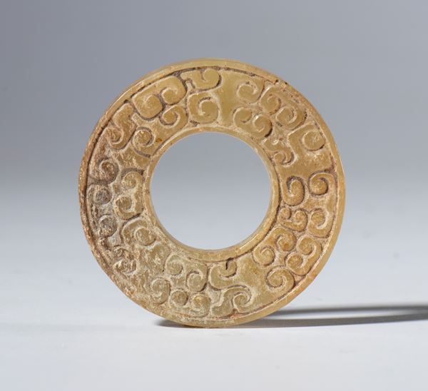 A nephrite jade BI disc engraved with a cloud motif. China, 20th century.