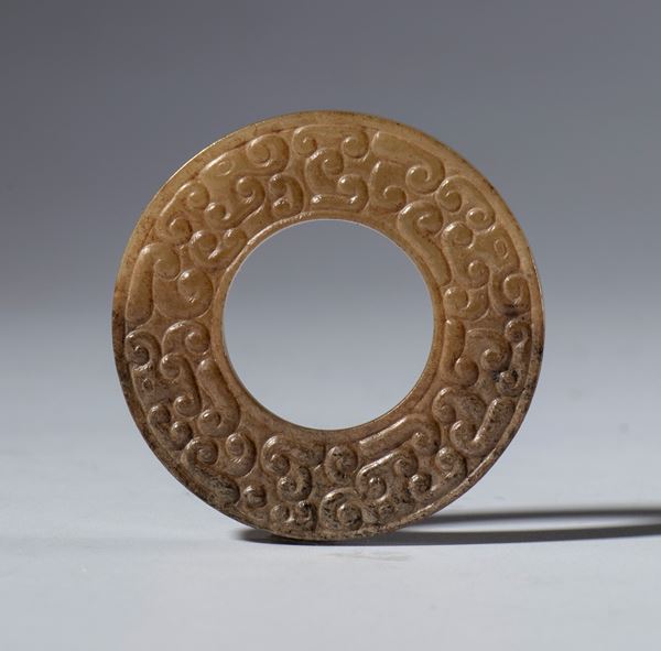 A nephrite jade BI disc engraved with a cloud motif. China, early 20th century.