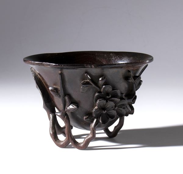 A refined Zitan wood libation cup with "prunus and magnolia" decoration. China, Qing Dynasty (1644-1912), late 18th-19th century.