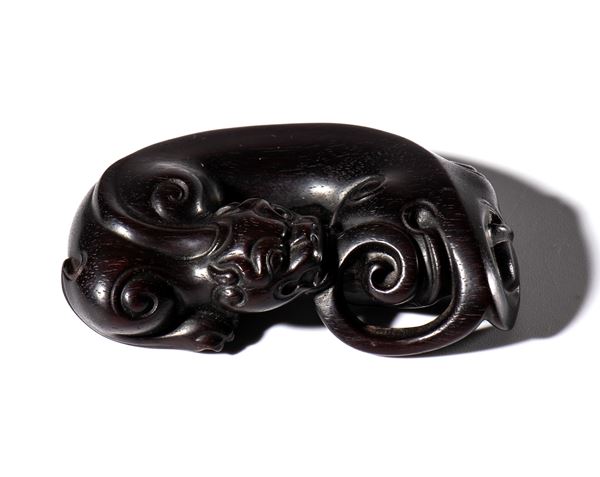 A dragon figurine carved from sandalwood. China, 20th century.