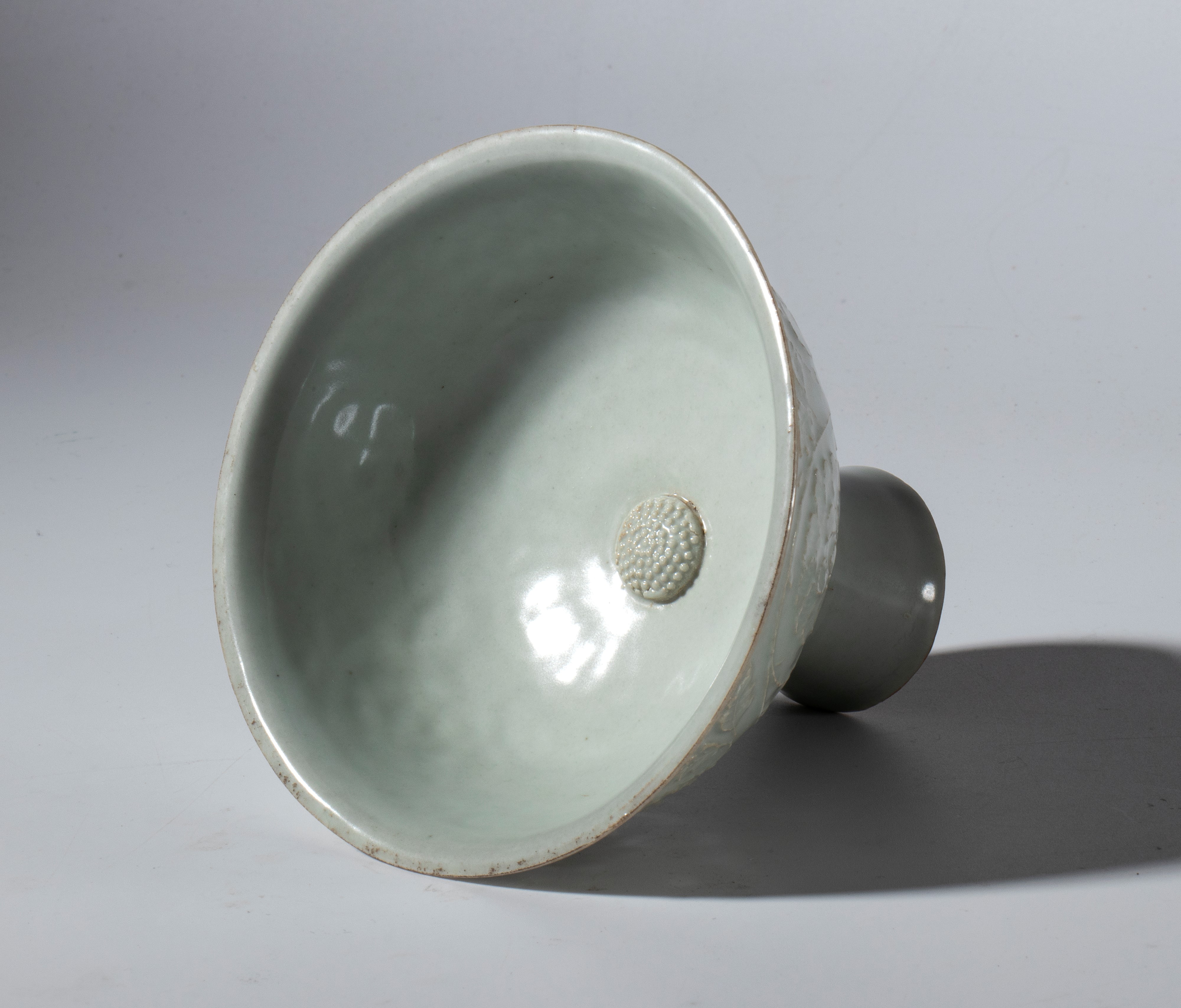 Coppa a stelo in ceramica Qingbai decorata a stampo con motivi floreali e smalto celadon. Cina, d...