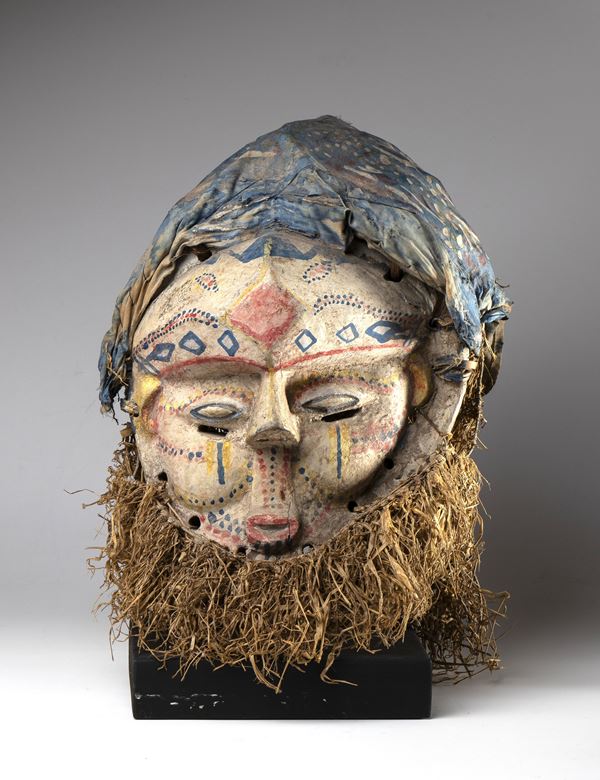 Painted wood, fabric, and plant fiber mask for initiation rites. Suku tribe, Africa, Democratic Republic of the Congo, ca. 1900.