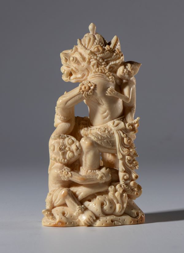 Finely carved marine ivory group depicting Garuda with monkeys and a demon. Indonesia, 19th century.