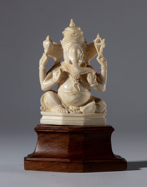 Small ivory elephant sculpture on a wooden base depicting Ganesha. India, 19th century.