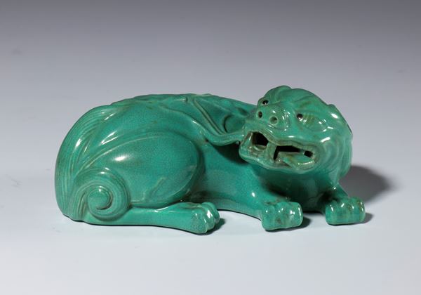 A jade-green glazed porcelain figurine depicting a mythical beast. China, 20th century.