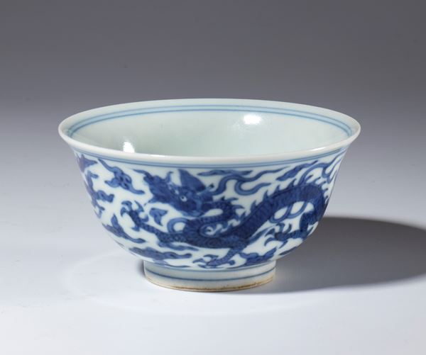 A small blue-painted porcelain bowl depicting dragons among clouds. China, Republic period (1912-1949).