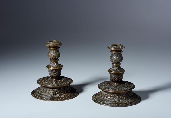 Pair of historiated candlesticks. Padua or Venice, 16th-17th century. Translucent black and brown patina.
