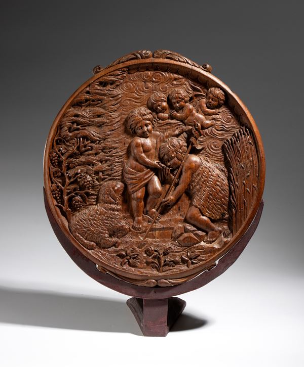 Round oak panel depicting the infant Jesus with St. John the Baptist and cherubs
