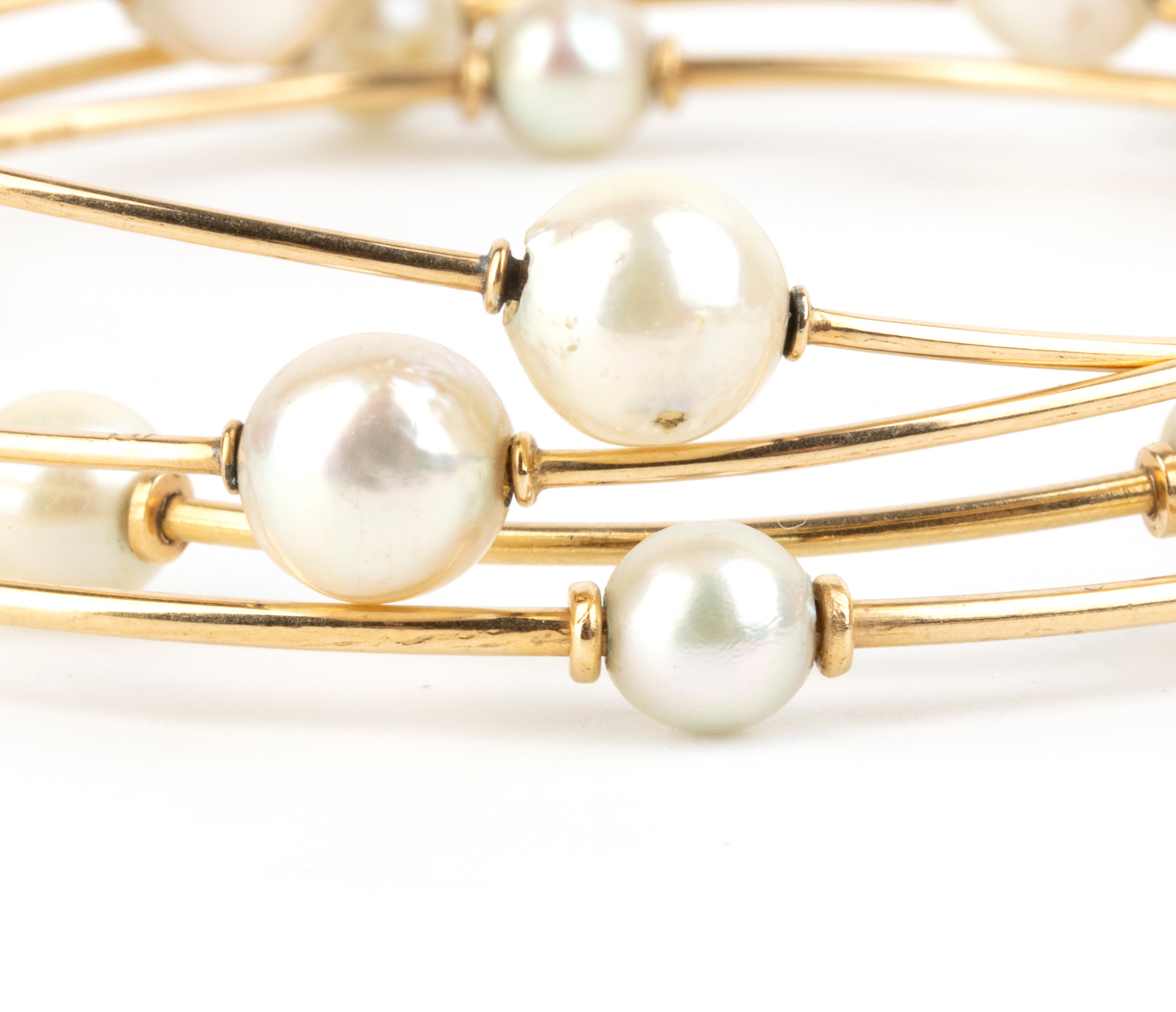 Oro giallo, quattro bracciali a cerchio con perle coltivate d’acqua salata