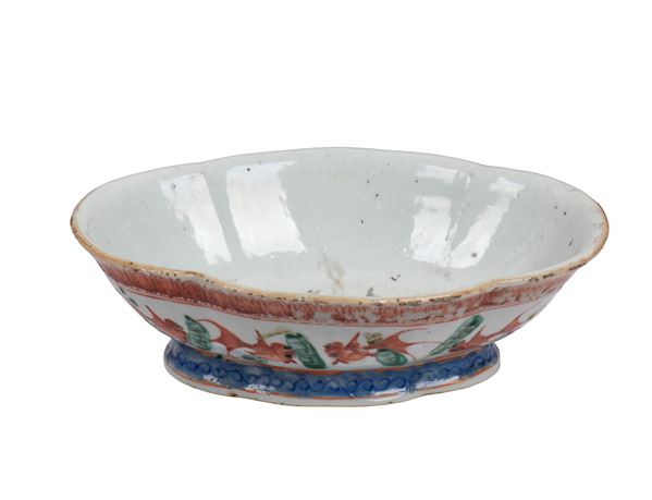 A polychrome enameled porcelain stand decorated with iron red fish. China, late Qing Dynasty, 20th century. 