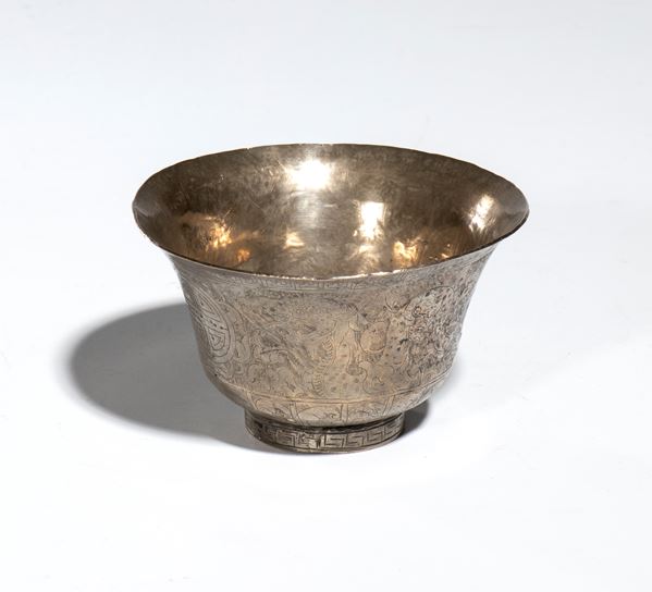 A silver-plated metal bowl with geometric carvings and traditional Himalayan decorative motifs. Tibet, 20th century.