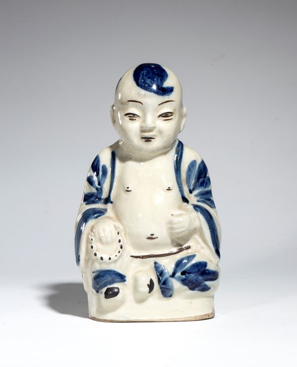 Piccola figura di fanciullo tongzi in porcellana bianca e  blu. Cina, inizio XX secolo