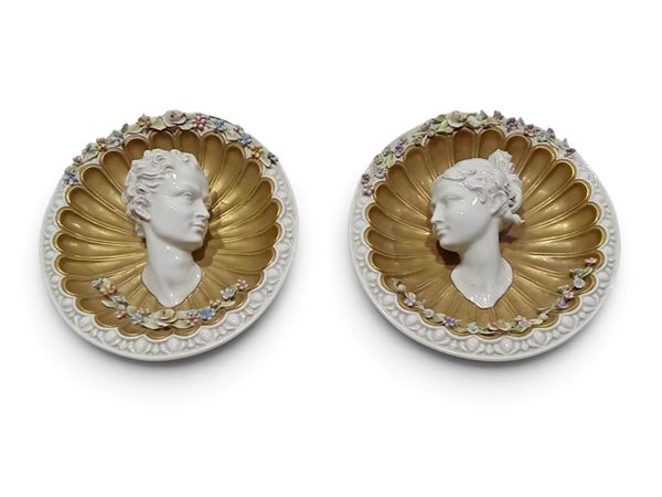 A pair of porcelain medallions depicting Bacchus and Ariadne