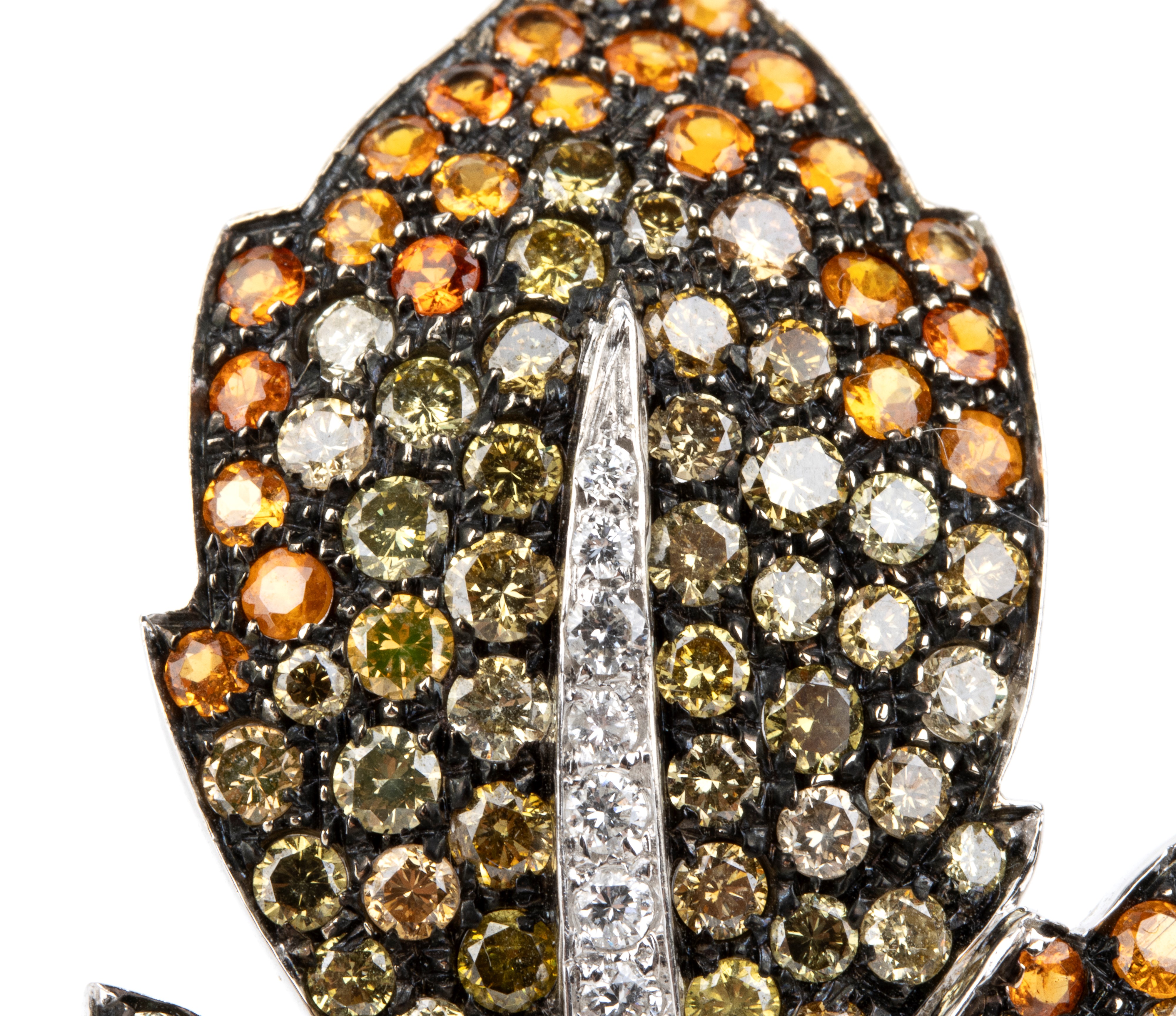 Spilla in oro bianco 18k, modello foglia con pavé di diamanti e corindoni arancio