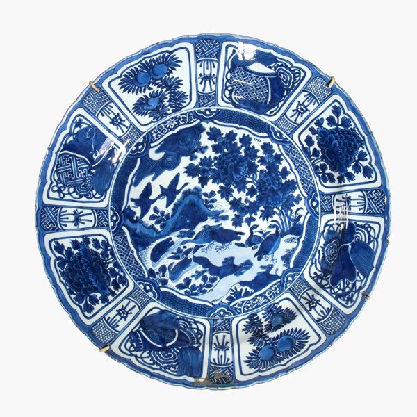 Large blue and white Kraak porcelain plate with a central medallion depicting birds and landscape elements. China, Qing Dynasty, 17th-18th century.