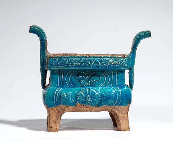 A turquoise-glazed ceramic incense burner, with a rectangular body raised on four feet and vertical, outward-curving handles. China, Ming Dynasty, 17th century.