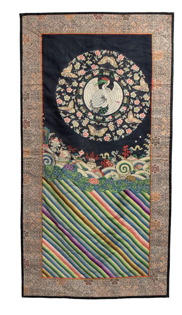 Robe fragment with embroidered silk rank badge decorated with a floral medallion and crane. China, Qing Dynasty, first half of the 19th century.