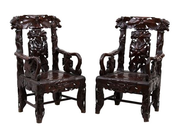 A PAIR OF CARVED HARDWOOD ARMCHAIRS
